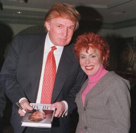 Donald Trump stands next to Ruby Wax, holding a copy of his book
