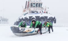 Teams compete during the Quebec Winter Carnival Ice Canoe Race. 