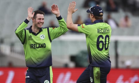 Ireland's George Dockrell, left, is congratulated by teammate Barry McCarthy after taking the wicket of England's Harry Brook.
