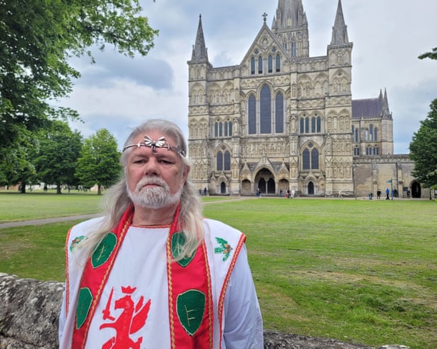 King Arthur Pendragon standing in front of a cathedral