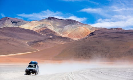 Jeep driving through the Atacama desert, Chile.
