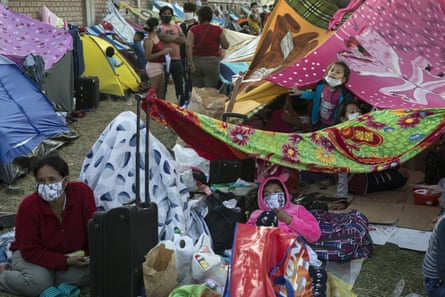 Migrants from Iquitos gather in a makeshift camp in Lima, Peru.