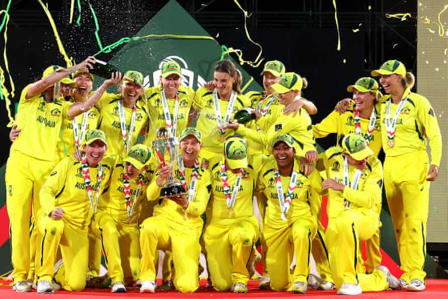 Australia celebrate with the trophy after winning the 2022 ICC Women’s Cricket World Cup final.