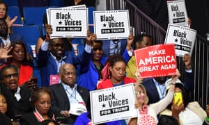 Herman Cain sits with other Trump supporters at the president’s rally in Tulsa on 20 June.