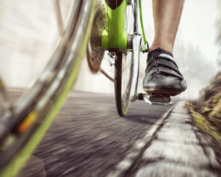 Detail of a green racing bicycle in motion on an old forest road.