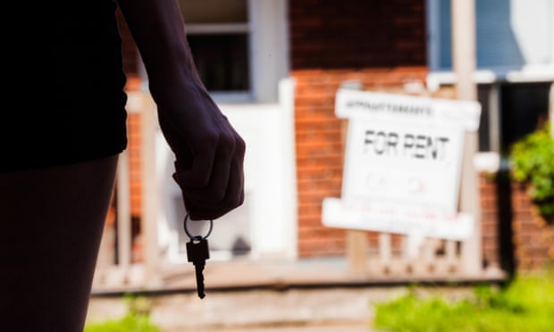 Young Woman standing with keys in front of her new apartment<br>