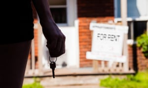 woman stands in front of rented property