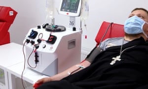 A Ukrainian priest who has recovered from Covid-19 donates blood plasma in Kharkiv