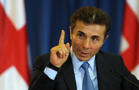 A man in a suit gestures