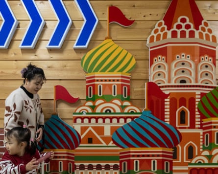 A Chinese woman with a young girl at a Russian shopping centre.