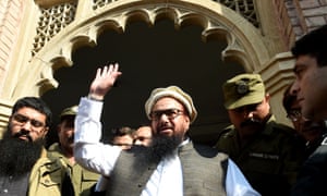 Hafiz Saeed waves to supporters as he leaves court in Lahore