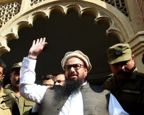 Hafiz Saeed waves to supporters as he leaves court in Lahore
