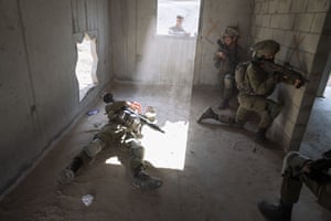 An Israeli soldier pretending to be dead Palestinian militant lies on the ground during a training session