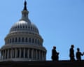 Three men in suits in silhouette, with white dome of US Capitol beyond them, under blue sky.