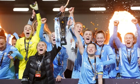 Manchester City’s injured captain, Steph Houghton, and Ellen White lift the Continental Cup.