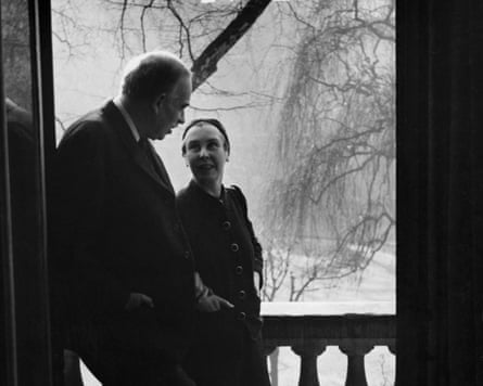 A couple on a terrace overlooking some trees