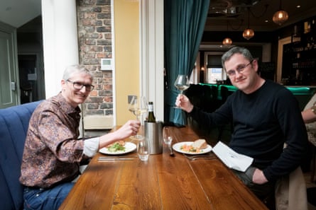 Lian and Carl raising a glass before they eat their starters