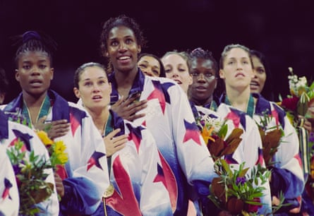 Sheryl Swoopes, Jennifer Azzi, Lisa Leslie, Carla McGhee, Katy Steding, Katrina McClain, Rebecca Lobo and Venus Lacey (left to right) look on from the podium.