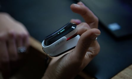 A woman who has long Covid reads her blood oxygen levels and heart rate.