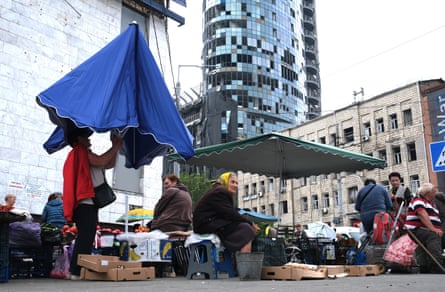 Stallholders operating in the shadow of an office block that lost many of its windows in a Russian strike last month.