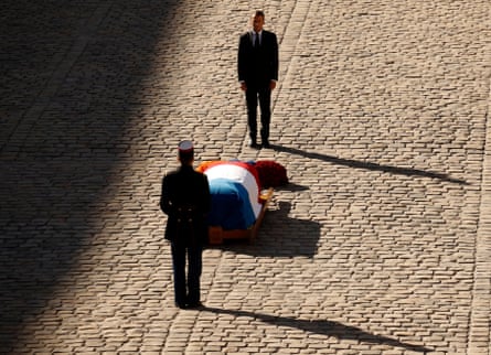 Emmanuel Macron stands behind the coffin of Charles Aznavour