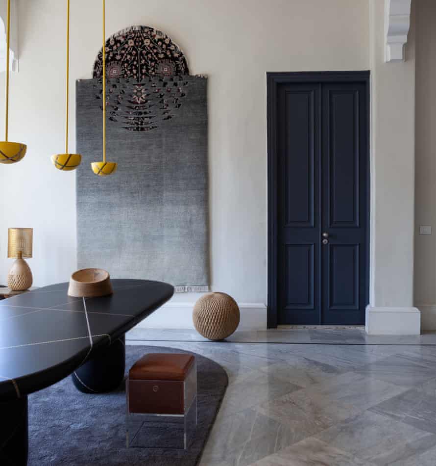 The living space with a dark door and an oval table on a rug