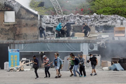 Participants take part in a civil defence drill during a simulation of a collapsed building in Taipei