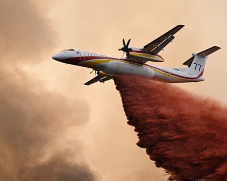A De Havilland Canada Dash 8-400 drops fire retardant over a forest near Saint-Jean-d'Illac, during wildfires in southwestern France.