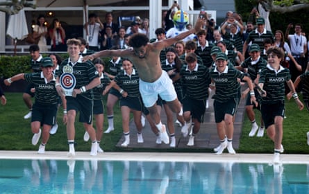 Fils jumps in a swimming pool, followed by the tournaments ballkids