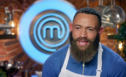 Cain speaking on screen with the MasterChef logo behind