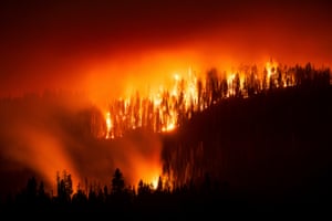 Trees torched by the Garnet fire light up the night sky with red and orange tones in the Sierra national forest