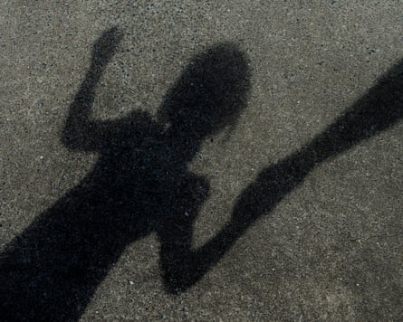 Shadow of an adult holding a girl's hand