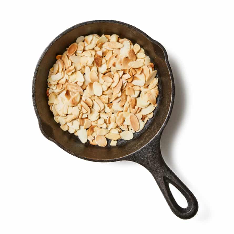 Felicity Cloake’s Coronation chicken 7a Toast the curry powder in a dry frying pan until fragrant. While the pan is still hot, toast the almonds for the topping, too, then set aside for later. Peel and finely chop the rest of the ginger, and chop the apricots (you can substitute other dried fruit here, if you prefer – sultanas, though not in the original, still feel retro).