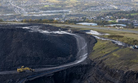 A digger at Ffos-y-Fran opencast coalmine in Merthyr Tydfil, Wales. The licence for the opencast coal mine expired months ago, but miners continue to dig hundreds of tons of coal a day