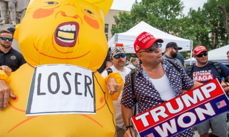 People rally for and against Trump’s indictment outside the courthouse in Washington DC on 3 August.