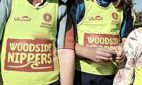 Children wearing Western Australian Nippers uniforms with Woodside logo.
