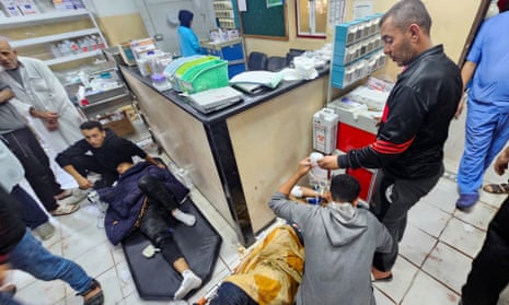 Palestinians wounded in Israeli strikes lie on the floor as they are assisted at the Indonesian hospital.
