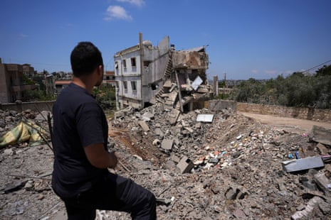 A man views the site of a previous Israeli strike in Kfar Sir in the Nabatieh district of southern Lebanon.
