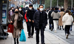 People wear masks to prevent contracting Covid-19 in downtown Seoul on 5 January.