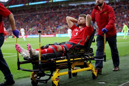 Wales’s Neco Williams is taken around the touchline on a stretcher.
