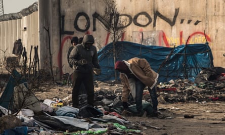 London calling? People pick through the remains of shelters in the dismantled part of the Jungle, cleared of some 1,500 people.