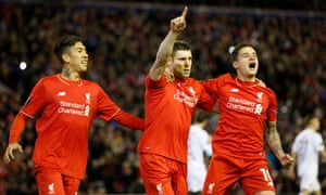 James Milner, centre, celebrates with team mates after scoring the first goal for Liverpool.
