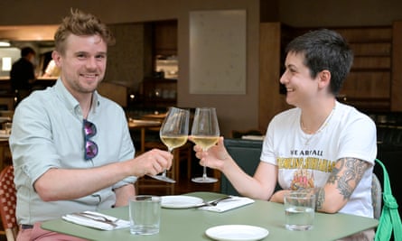 Two people sitting talking at a restaurant table