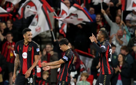 Rayan celebrates scoring with Bournemouth teammates as fans wave flags behind them