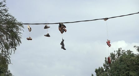 Boots hanging on electricity wires at the entrance of Kibagare.