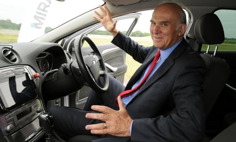 Vince Cable sits in a driverless car
