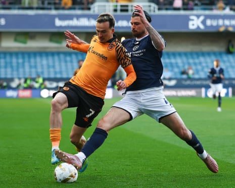 Wembley on the line at The Den — Liam Millar of Hull City is tackled by Tristan Crama of Millwall.