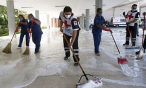 Members of the Red Cross, nurses, and workers from the cement company CEMEX sanitise the Red Cross Hospital’s ambulance area in Monterrey, state of Nuevo Leon, Mexico, on 28 April 2020 during the coronavirus pandemic.