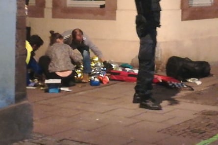 Picture taken with a mobile phone shows rescuers treating an injured person in the streets of Strasbourg.