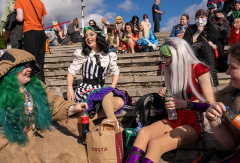 Caitlin Tumber, 24, Catherine Mariah, 26, Emily Martin, 24 and Meghan Tumbler, 20, dressed in costumes, are among several people eating lunch on the steps outside  MCM Comic-Con